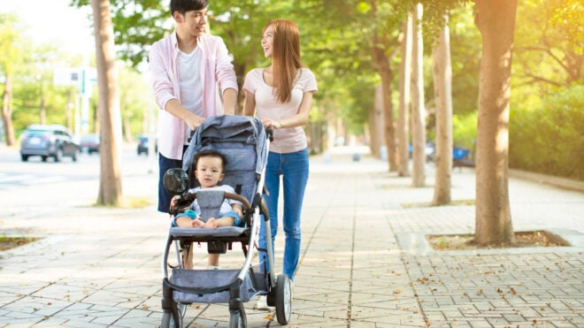 summer stroller accessories, stroller fan, happy family with baby carriage walking in the park