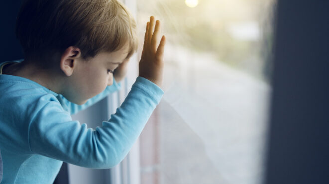 boy looking out window