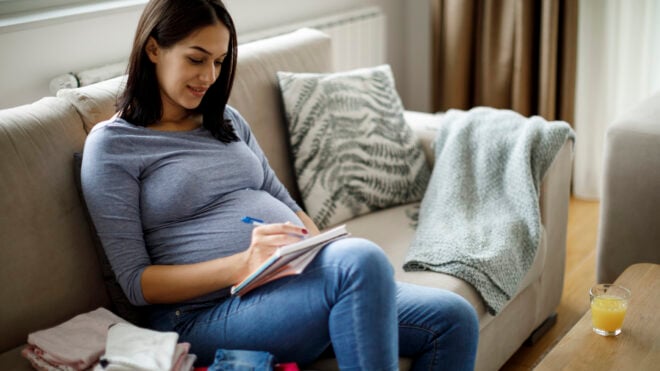 Pregnant woman making notes