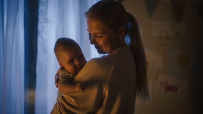 A woman holding a baby