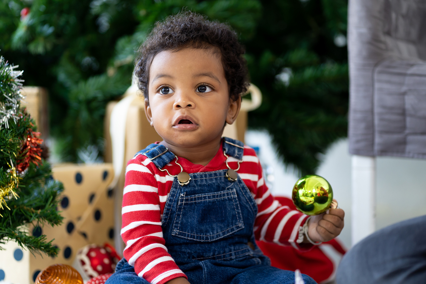 Baby boy holding an ornament