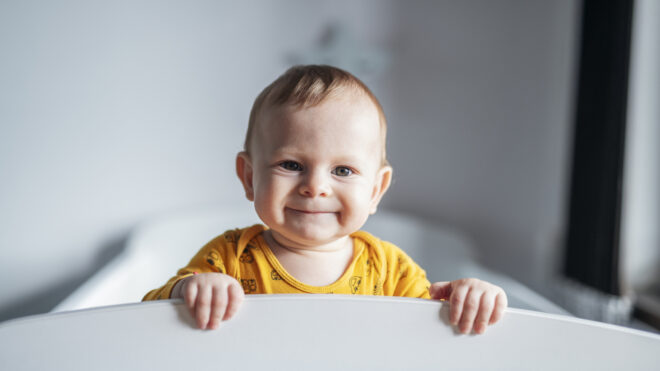 Smiling baby in a crib