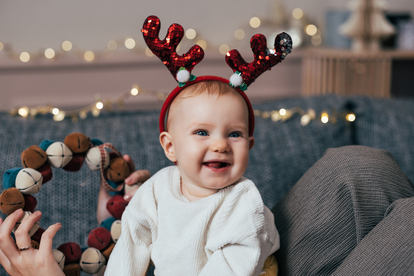 Baby girl wearing reindeer antlers