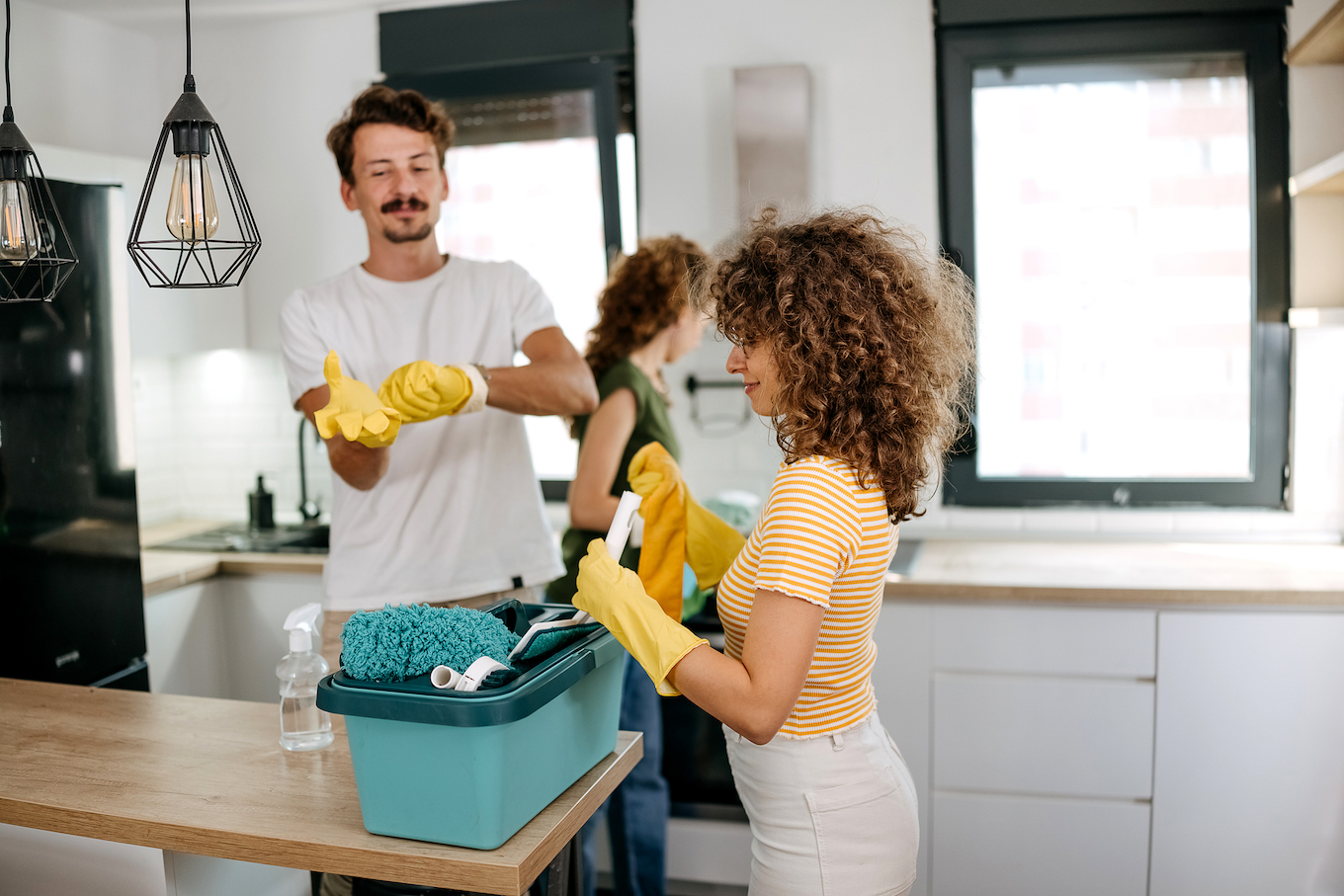 Friends clean the kitchen together