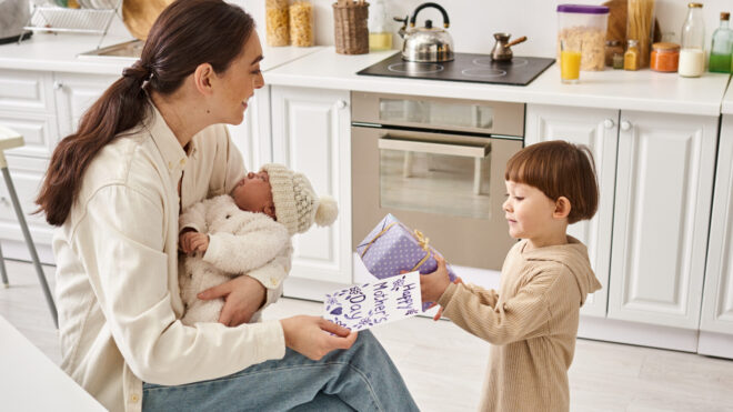 A devoted mother enjoys time with her two young sons in their bright kitchen.