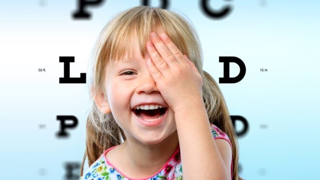 A kid doing an eye exam
