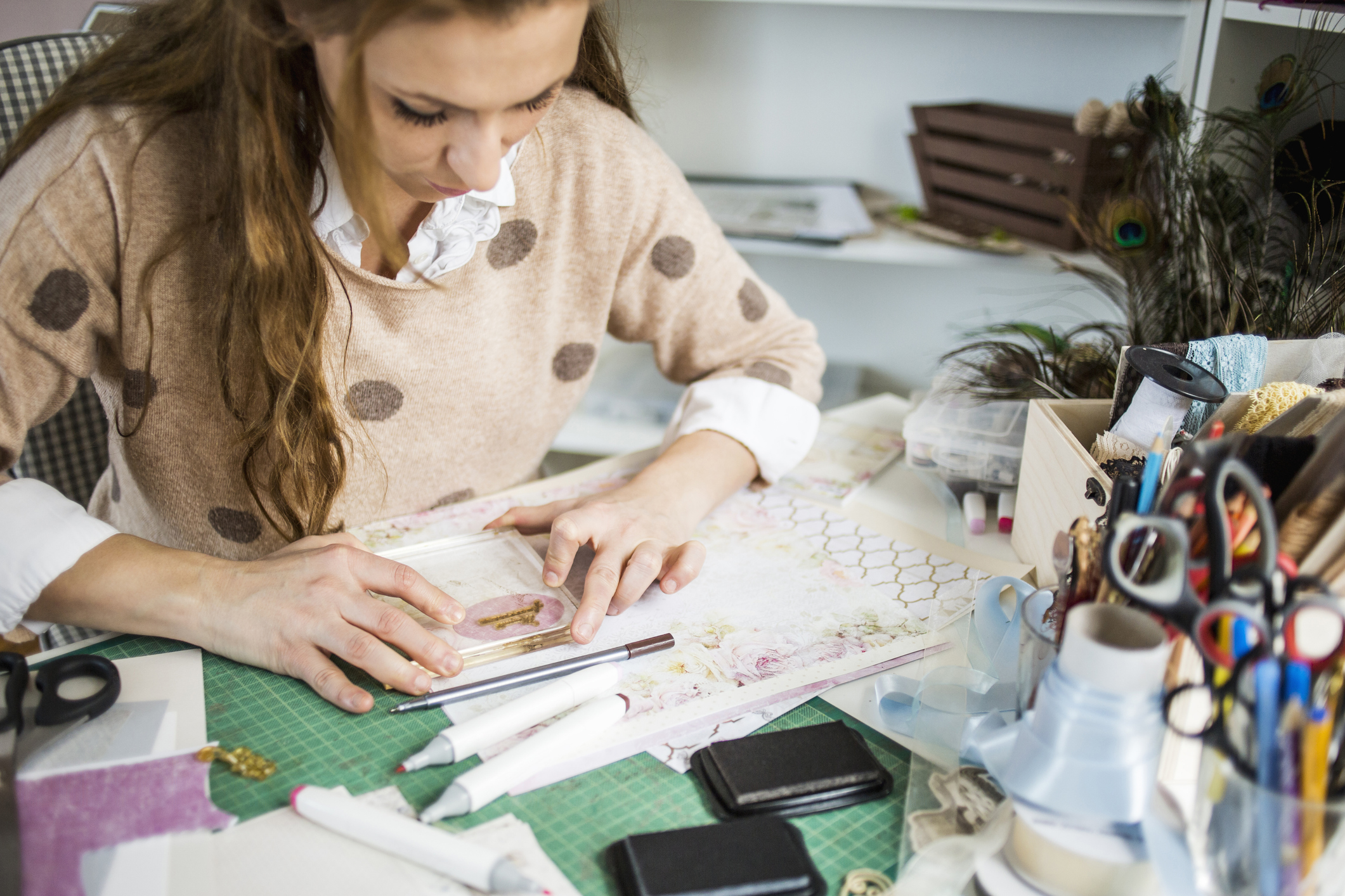 Young woman making handmade cards in her atelier, small business owner
