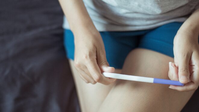 Woman looking at pregnancy test